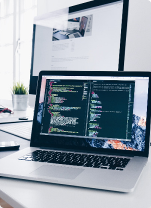 computer on a office desk with code on it